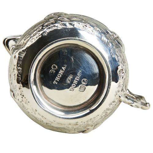 115 - A SQUAT CIRCULAR CREAM JUG, LONDON 1867A small cream jug chased with tavern scenes with a handle cas... 