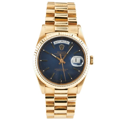 ROLEX: AN 18CT GOLD OYSTER PERPETUAL DAY-DATE WRISTWATCH; Ref 18238, serial number S634304; fully signed blue dial with apertures for day and date, centre seconds, 18ct gold president bracelet with concealed clasp, 36mm. c 1993.