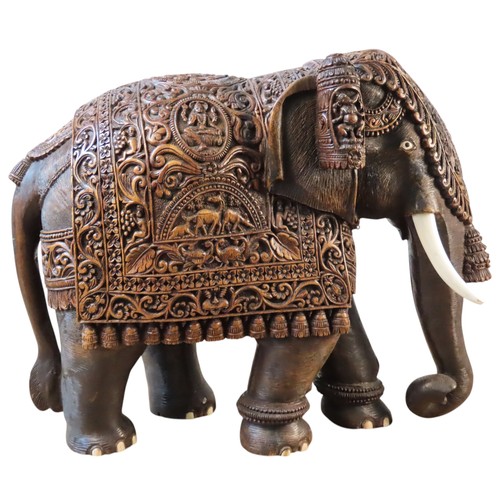 A FINELY CARVED INDIAN HARDWOOD ELEPHANT