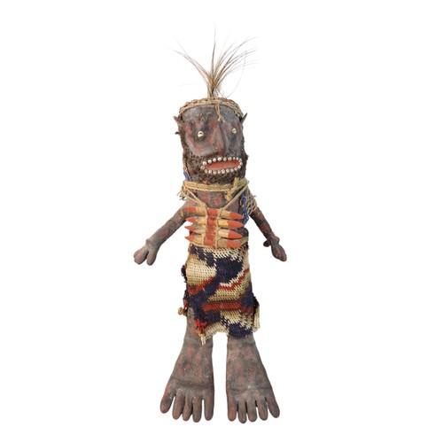A MENDI 'COMPENSATION' OR 'REVENGE' DOLL, traditionally made with pandanus leaves, bilum string, shells, wood, seeds and objets trouve with pigments. 47 cms high