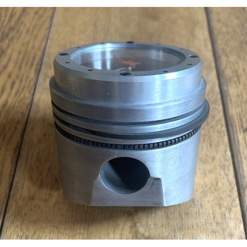 130 - A FORD DESIGN PISTON DESK CLOCKAn original piston adapted to accommodate a digital clock. 90mm in di... 