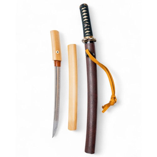 A FINE TANTO, mumei, sugata construction, of flat wedge section hira zukuri and shallow peaked back, ihore mune, the forging pattern is jihada with fine packed wood grain, ko mokume with scattered ji nie, with wide hamon of irregular patterns, the nakago in funagata form with single mekugi ana in shira saya together with a full tanto kosherai, the saya with kurikata, the tsuka with nunome fuchi and kashira with a rinzu design keyfret pattern symbolic of Buddha's heart and various brocade and basketwork patterns all finely inlaid, silver menuki of Japanese fishermen, the tsuka shark skin and same, the fine rounded rectangular tsuba in fine gold Kenjo style nunome and suggestive of late 17th century Genroku period work, possibly a gift from one Daimyo to another, the saya with flecks of fine gold powder with black lacquer kurikata. Wooden blade. 