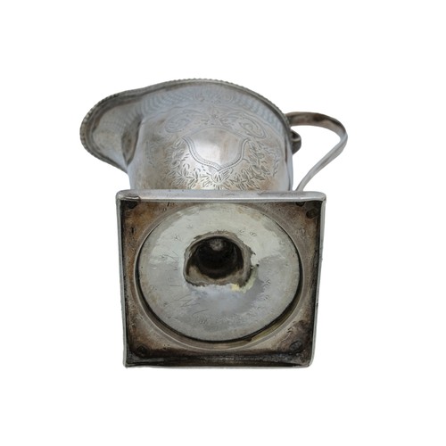 27 - A GEORGE III HELMET FORM SILVER CREAMERLONDON 1784with a 'C' scroll handle, raised on a square foot,... 