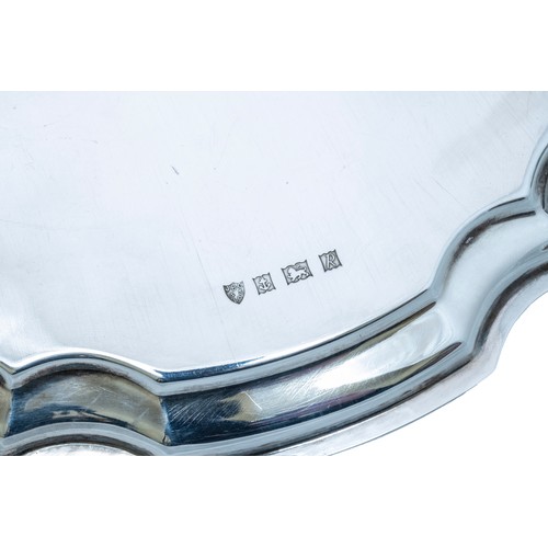 55 - A SILVER SALVERBIRMINGHAM 1966circular form with scroll edge, raised on four scroll feet20.5 cm diam... 