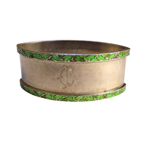 32 - A SILVER AND ENAMEL NAPKIN RING BY LIBERTY & CO.planished navette form with two bands of enamell... 