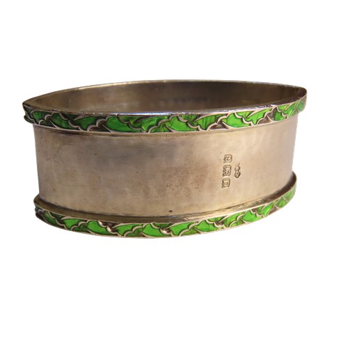 32 - A SILVER AND ENAMEL NAPKIN RING BY LIBERTY & CO.planished navette form with two bands of enamell... 