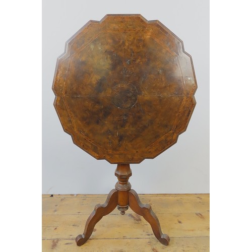 31 - A WALNUT TILT-TOP TABLE with shaped top and tripod base. 65 cms diam 73 cms high