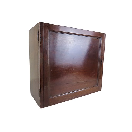 17 - A MAHOGANY TABLE TOP CABINET OF DRAWERS19TH CENTURYthe panelled door opening to reveal an array of s... 