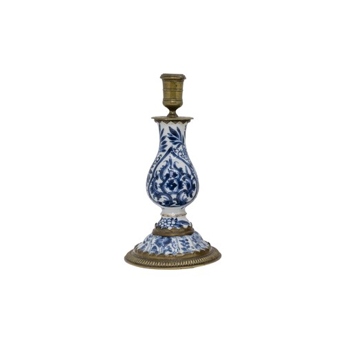 57 - A CHINESE BLUE AND WHITE CANDLESTICKKANGXI PERIODwith gilt-metal mounts 19cm highPROVENANCE: From th... 