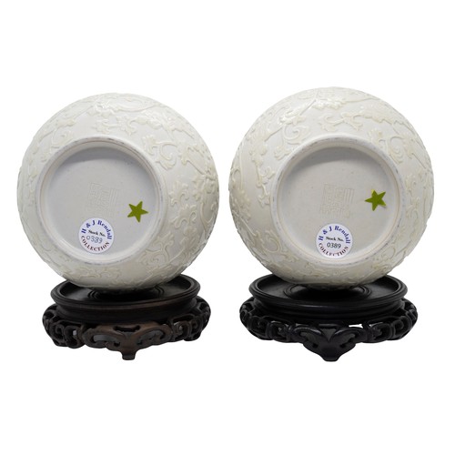 19 - A PAIR OF RELIEF-CARVED WHITE-GLAZED VASESIMPRESSED DAOGUANG MARKS, 20TH CENTURYwith hardwood stands... 