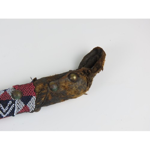 A NATIVE AMERICAN PLAINS STONE WAR CLUB, the ovoid stone head bound ...
