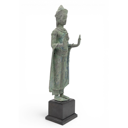 303 - A KHMER BRONZE FIGURE OF BUDDHAANGKOR PERIOD, 12TH CENTURYcast standing with hands in abhayamudra, r... 