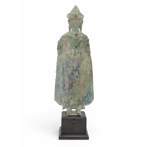 303 - A KHMER BRONZE FIGURE OF BUDDHAANGKOR PERIOD, 12TH CENTURYcast standing with hands in abhayamudra, r... 