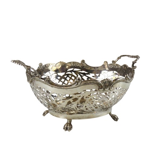 44 - A DUTCH SILVER SWEETMEAT BASKETwith scrolling ring handles and pierced lattice sides, raised on four... 
