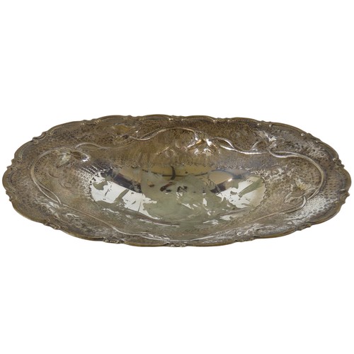 51 - A CONTINENTAL SILVER OVAL FORM DISHwith repousse vine decorated border, raised on four feetstamped 9... 