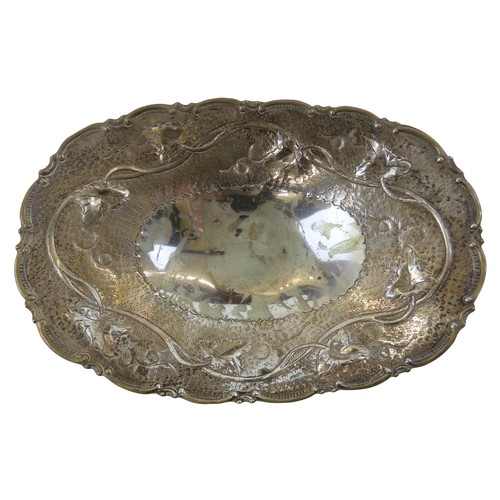 51 - A CONTINENTAL SILVER OVAL FORM DISHwith repousse vine decorated border, raised on four feetstamped 9... 