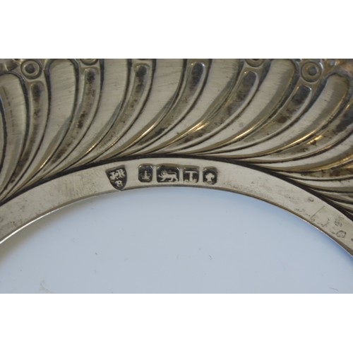 55 - TWO EDWARDIAN SILVER HEART SHAPED REPOUSSE DISHESwith putti and bird decoration(9.8 x 10.7 cm max)to... 