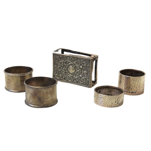 31 - A MIXED GROUP OF FOUR SILVER NAPKIN RINGSconsisting of a pair of engine turned rings and two planish... 