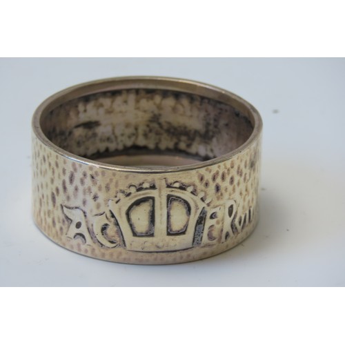 31 - A MIXED GROUP OF FOUR SILVER NAPKIN RINGSconsisting of a pair of engine turned rings and two planish... 
