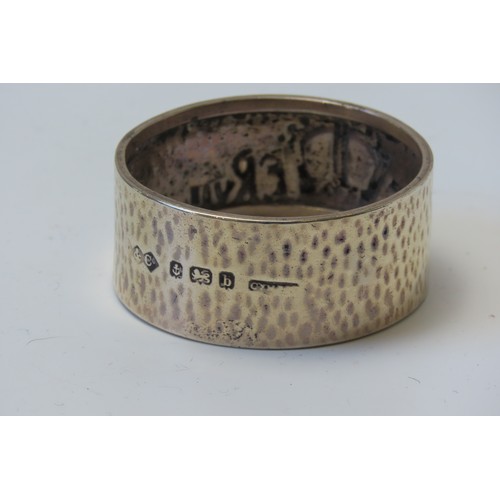 31 - A MIXED GROUP OF FOUR SILVER NAPKIN RINGSconsisting of a pair of engine turned rings and two planish... 