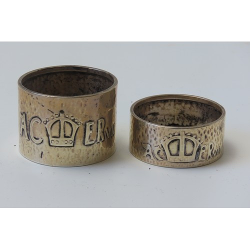 31 - A MIXED GROUP OF FOUR SILVER NAPKIN RINGSconsisting of a pair of engine turned rings and two planish... 