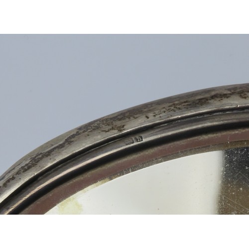 1 - A FILLED SILVER CANDLESTICK AND SILVER BACKED HAND MIRRORthe candlestick marked Birmingham, 1939 (20... 