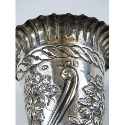 25 - A PAIR OF EDWARDIAN SILVER BUD VASESLONDON 1902with scalloped rims above repousse decorated tapering... 