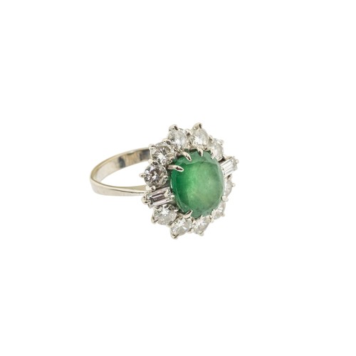 221 - AN EMERALD AND DIAMOND RING,the central oval cut emerald claw set within a surround of brilliant cut... 
