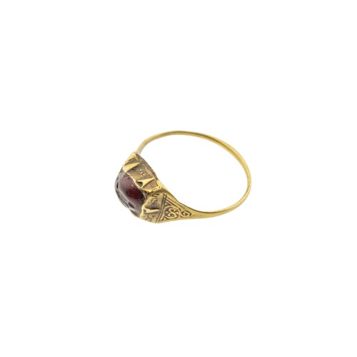 244 - AN ISLAMIC SELJUK INTAGLIO GARNET TALISMAN RING, 13th century, the oval garnet carved with a bird, w... 