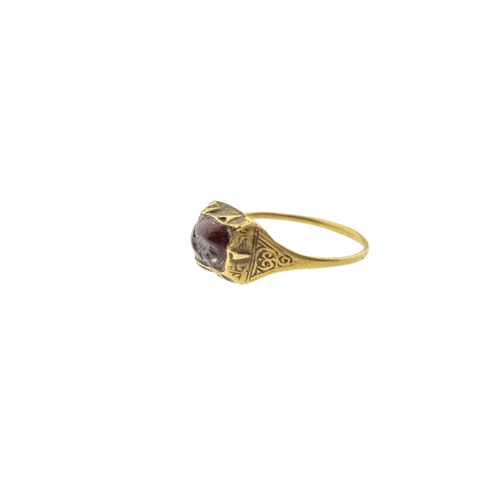 244 - AN ISLAMIC SELJUK INTAGLIO GARNET TALISMAN RING, 13th century, the oval garnet carved with a bird, w... 