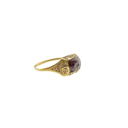 244 - AN ISLAMIC SELJUK INTAGLIO GARNET TALISMAN RING, 13th century, the oval garnet carved with a bird, w... 