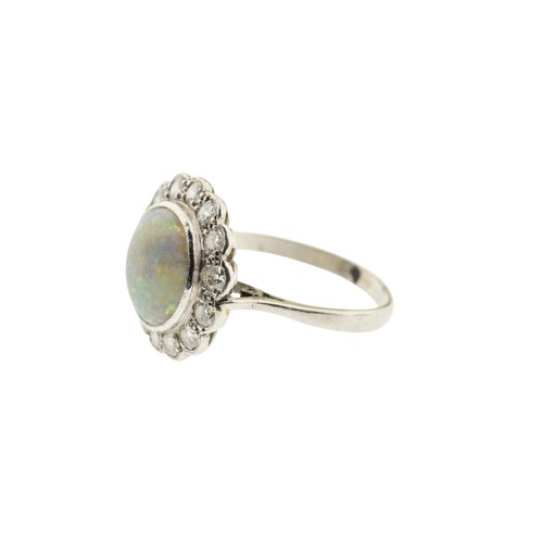 212 - AN EARLY 20TH CENTURY OPAL AND DIAMOND RING, the circular cabochon opal, in a collet setting, within... 