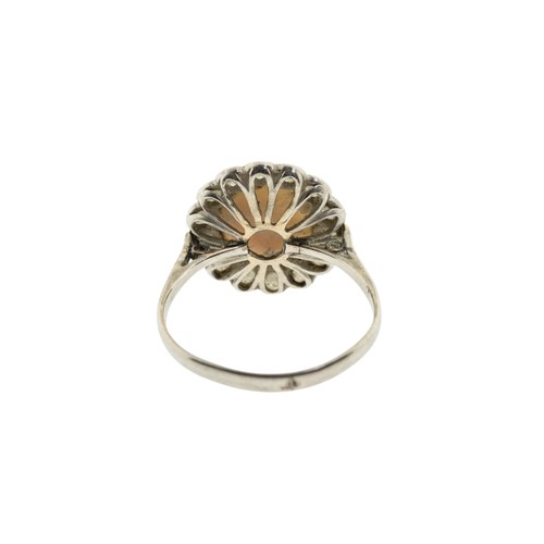 212 - AN EARLY 20TH CENTURY OPAL AND DIAMOND RING, the circular cabochon opal, in a collet setting, within... 