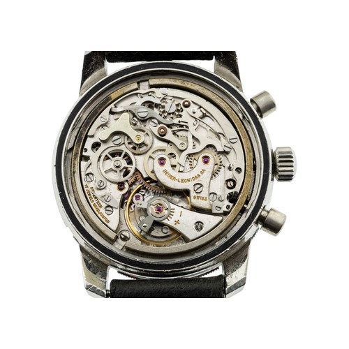 256 - HEUER: A STEEL AUTAVIA CHRONOGRAPH WRISTWATCH; Ref 2446, Serial No. 110075, reverse panda dial, sign... 