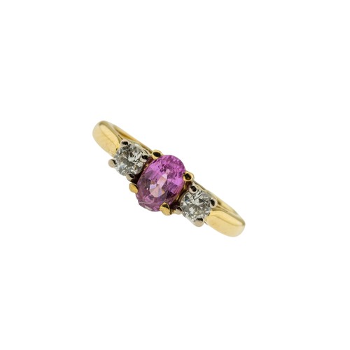 218 - A PINK SAPPHIRE AND DIAMOND RING,the oval cut pink sapphire claw set between two brilliant cut diamo... 