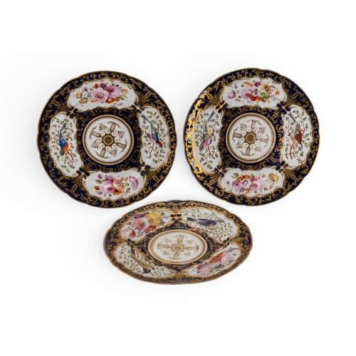 56 - A COALPORT PART SERVICE ornately decorated with birds and flowers on a dark blue ground with heavy g... 