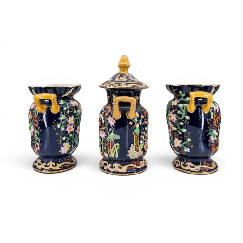 17 - A PAIR OF MASON'S VASES, boldly decorated in meandering blooms and butterflies on a blue ground with... 