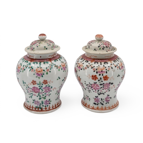 55 - A PAIR OF CHINESE FAMILLE ROSE COVERED VASESQING DYNASTY, 19TH CENTURYthe baluster sides painted wit... 