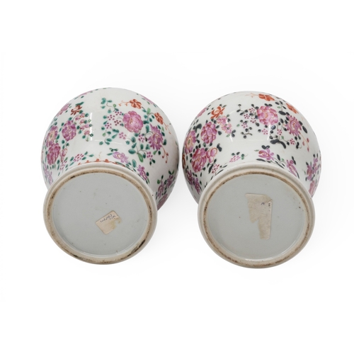 55 - A PAIR OF CHINESE FAMILLE ROSE COVERED VASESQING DYNASTY, 19TH CENTURYthe baluster sides painted wit... 
