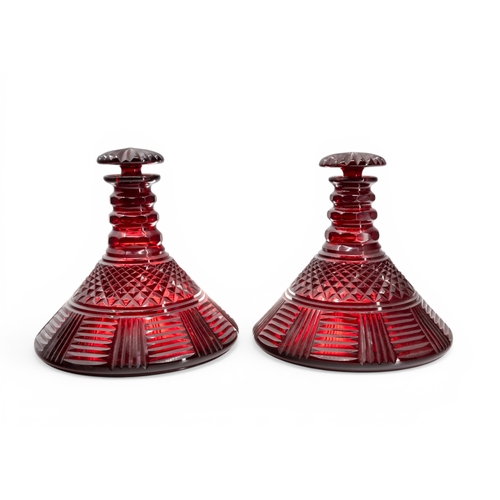 13 - A PAIR OF BOHEMIAN CUT GLASS RUBY SHIPS DECANTERS with mushroom stoppers.20 cms high.