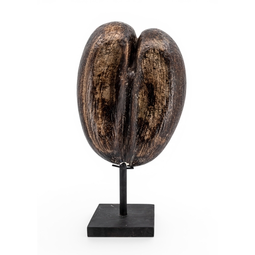 41 - A CERAMIC COCO DE MER with naturalistic finish and with a wooden stand. 32 x 24 cms