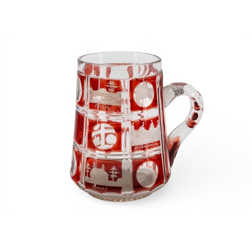 52 - A BOHEMIAN RUBY FLASH SPA TANKARD, 19th century, cut with scenes of buildings and places.13.75 cms... 
