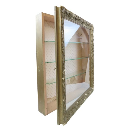 38 - A VINTAGE WALL MOUNTED BIJOUTERIE CABINETthe gilt gesso framed cabinet door enclosing three interior... 