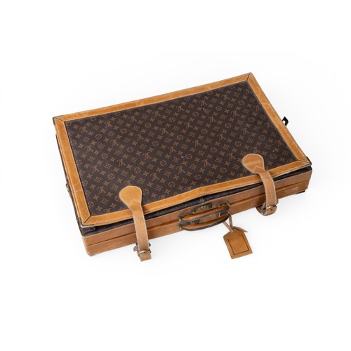 24 - A LOUIS VUITTON STYLE EXPANDING CASE with monogrammed body and leather binding and borders. 47 x 68 ... 