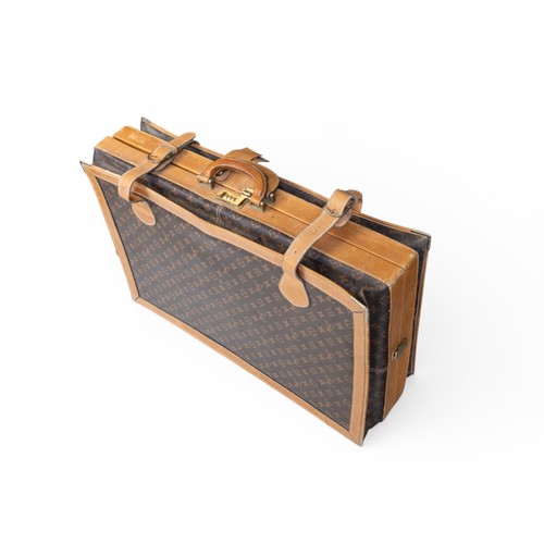 24 - A LOUIS VUITTON STYLE EXPANDING CASE with monogrammed body and leather binding and borders. 47 x 68 ... 
