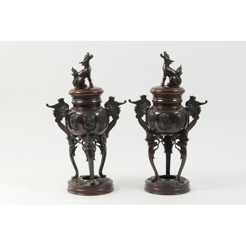 426 - Pair of Japanese bronze incense burners, Meiji (1868-1912), pierced covers surmounted with a mythica... 