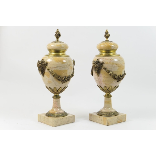 486 - Pair of French ormolu mounted marble cassoulet urns, with flame finial, rams mask and floral garland... 