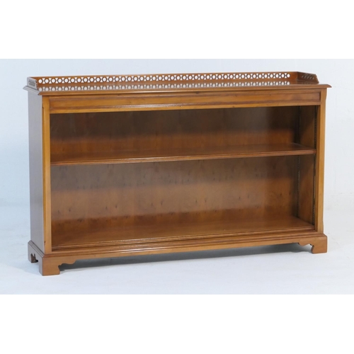 524 - Quality modern yewood open bookcase, having a three quarter gallery back and two shelves, raised on ... 