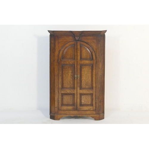 551 - Oak flat front hanging corner cupboard, early 19th Century, having a moulded cornice over two fielde... 