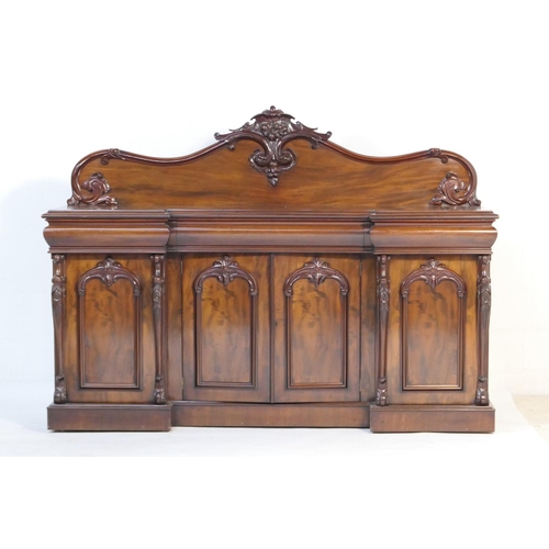 555 - Victorian mahogany breakfront sideboard, circa 1845-60, the back panel with a carved fruiting crest ... 